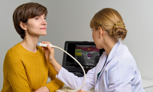 Faceless medical worker conducting thorough scan of cervical veins and arteries, examines throat. Modern devices for ultrasound diagnostics. Appointment of patient with problems with endocrine system